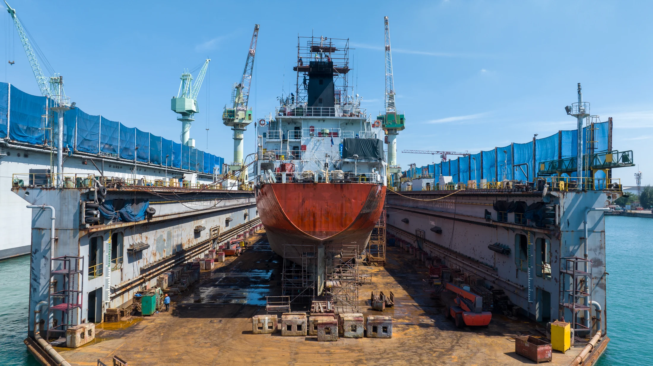 Large vessel undergoing maintenance in dry dock
